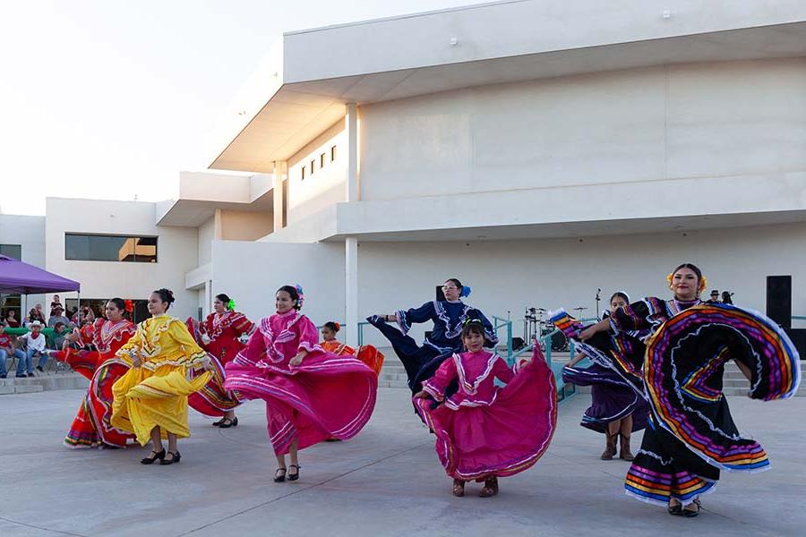 Traditionl dancers perform in colorful dresses during Hispanic Heritage celebration at San Juan College, an emerging HSI.